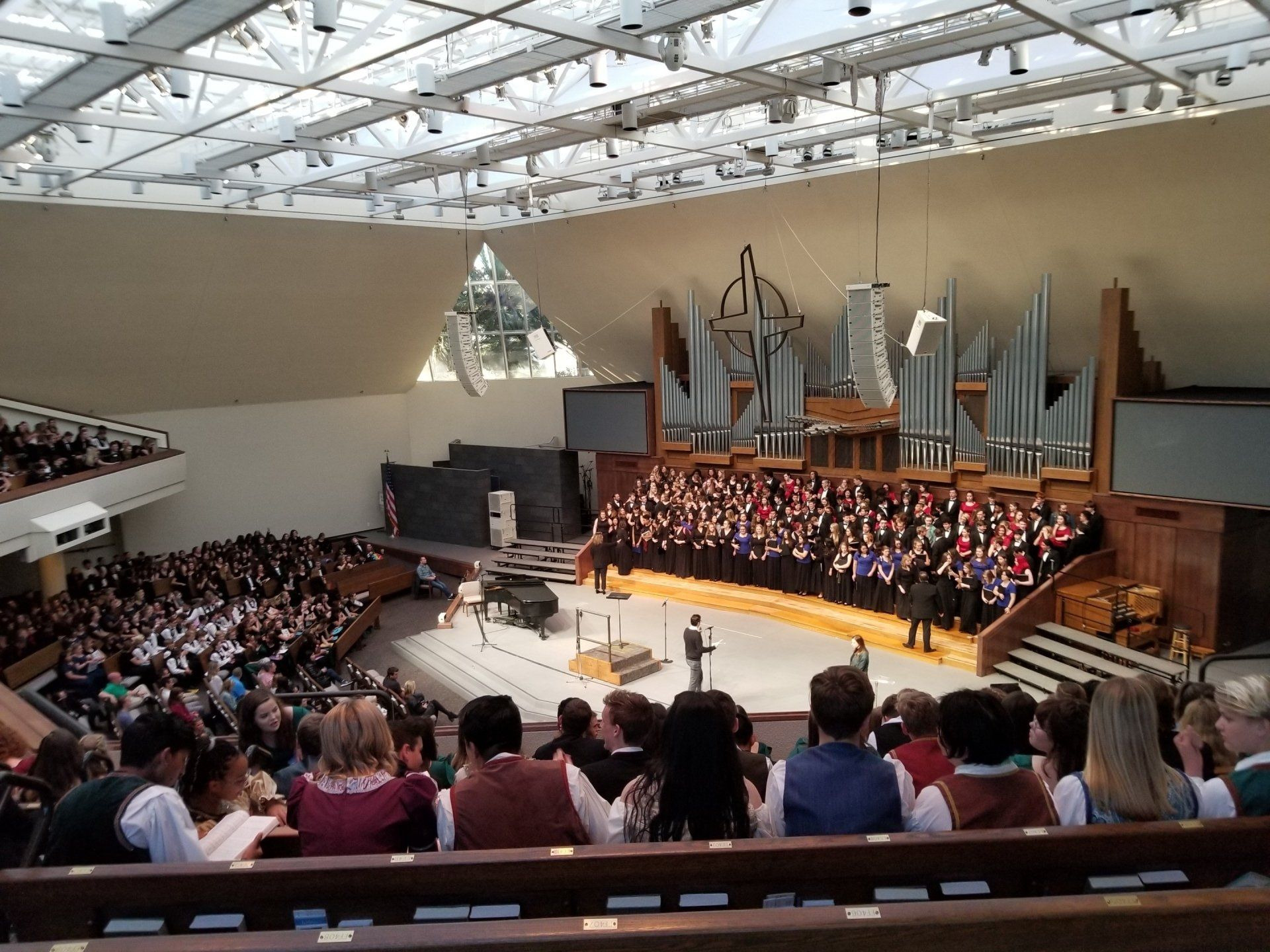 At the American Choral Festival in Anaheim, a choir sings beneath a pipe organ while the audience fills the nave.